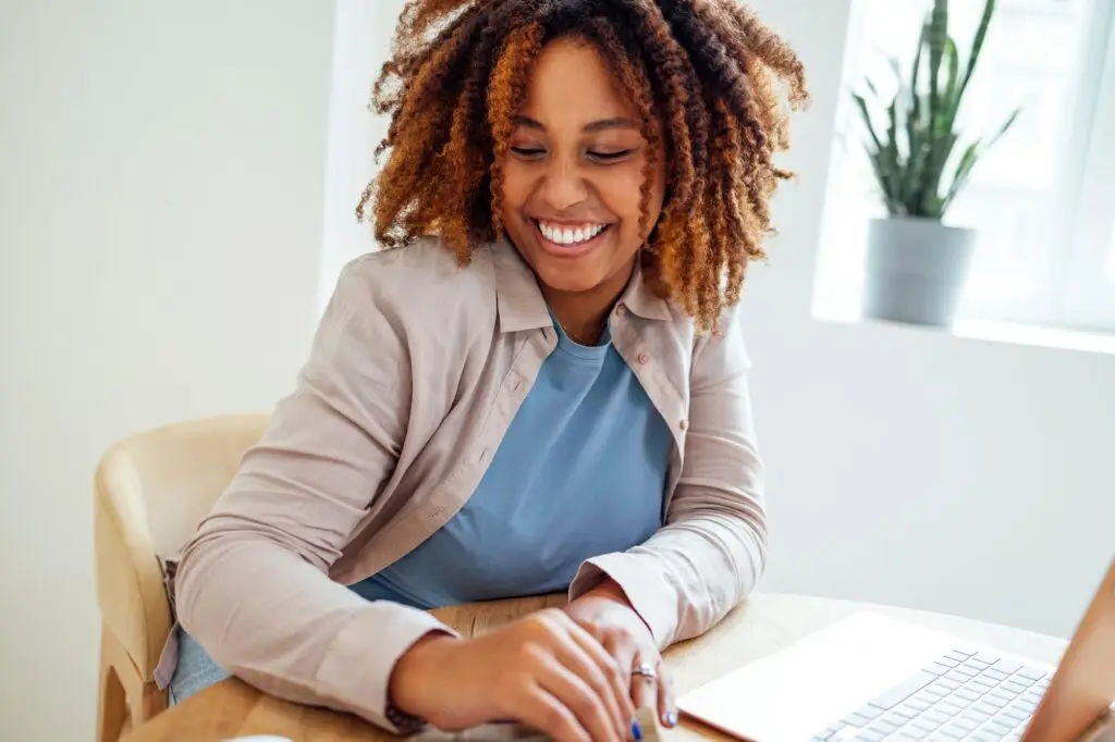 Young African American woman is working on a laptop.